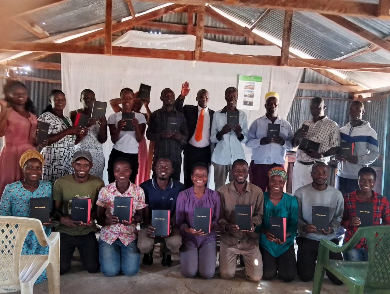 Community members receiving Bibles during a Rescue Hope Kenya gathering